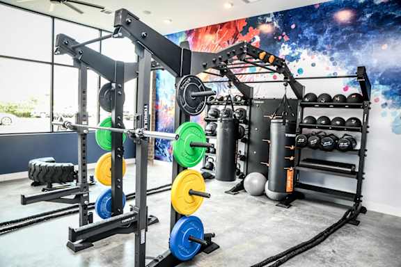 Modern fitness center featuring an abstract mural at NOVI in Concord, North Carolina.