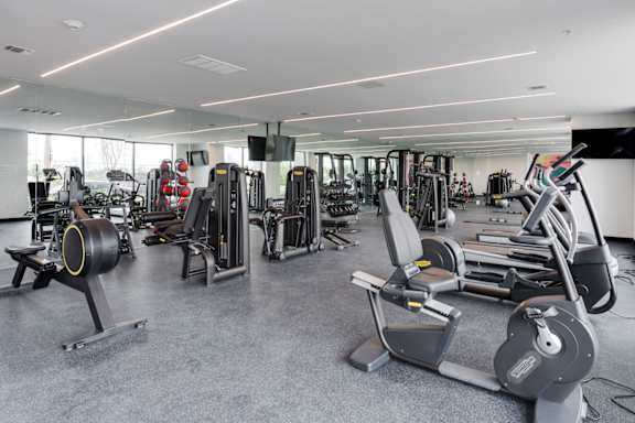 A gym with a variety of equipment including treadmills, weights, and exercise machines.at 829 Garfield, Jersey City, NJ