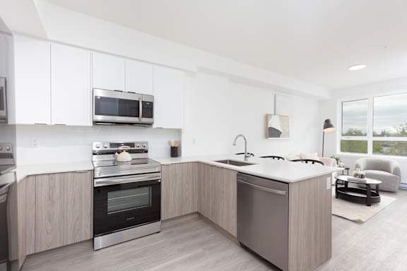 A modern kitchen with a stainless steel oven and microwave.