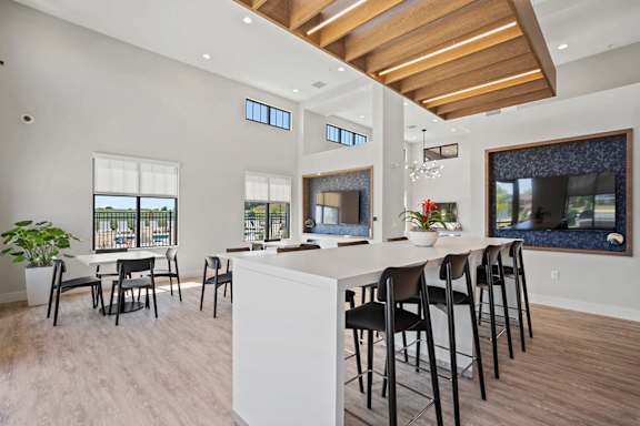a kitchen with a bar and chairs and a living room with a fireplace at Tivoli Green Apartments & Townhomes, Mount Pleasant