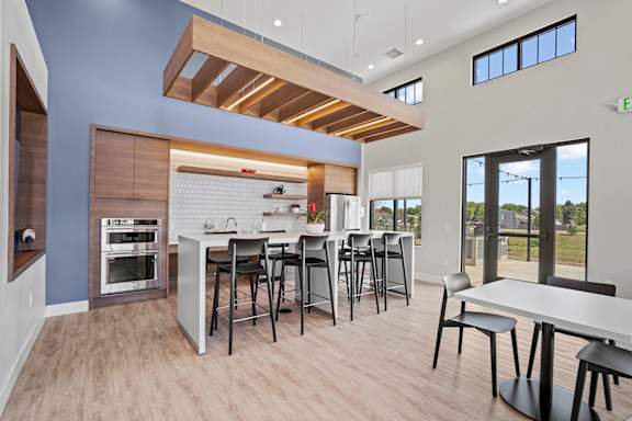 a kitchen with a bar and a dining area  at Tivoli Green Apartments & Townhomes, Mount Pleasant