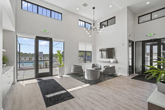 a living room with a table and chairs and sliding glass doors at Tivoli Green Apartments & Townhomes, Mount Pleasant