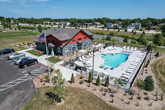 an aerial view of a swimming pool and building with a red house at Tivoli Green Apartments & Townhomes, Mount Pleasant
