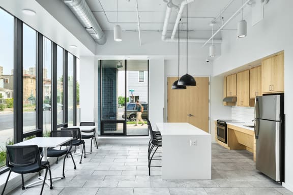 an open kitchen and dining area in an office building