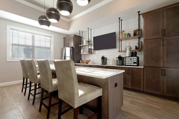 A kitchen with a table and chairs.