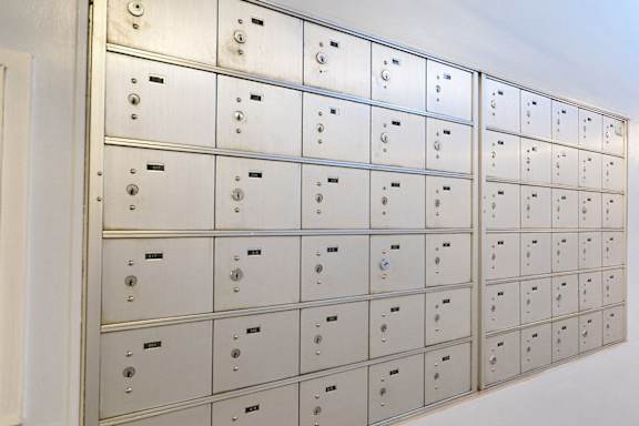 a wall of lockers with numbers on them at Capital Flats & Magnolia Square Apartments, North Carolina, 27601