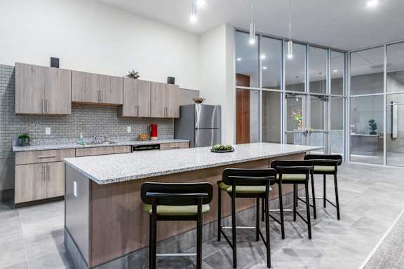 A kitchen with a bar stool and a counter.