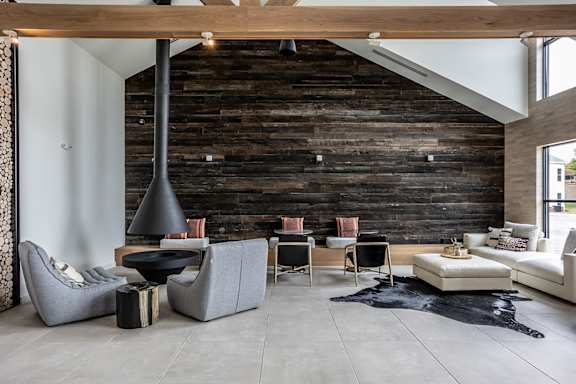 Lounge seating area and fireplace in multi-story clubhouse