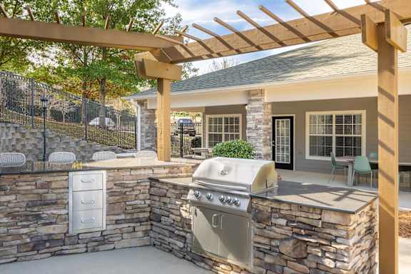 A stone wall with a grill on it.