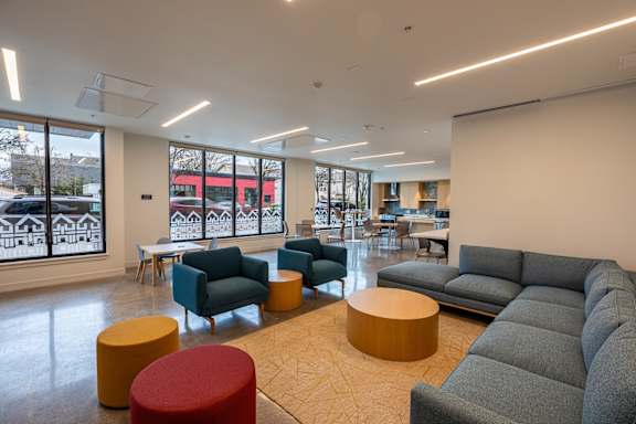 a lounge area with couches and chairs and tables in a lobby