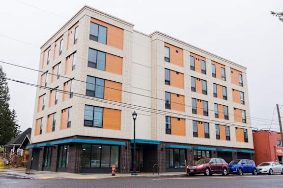 a large building with cars parked in front of it