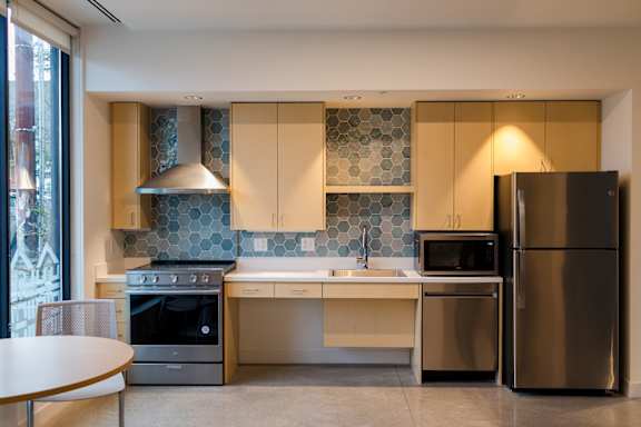 a kitchen with stainless steel appliances and a table