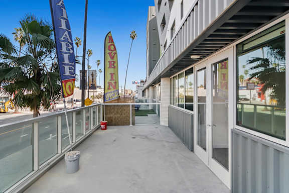 A balcony with a sign that says "MOVE IN" and a blue banner with the word "AVAILABLE" on it.