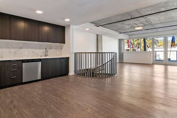 A kitchen with a marble countertop and a spiral staircase at Fusion Hollywood.