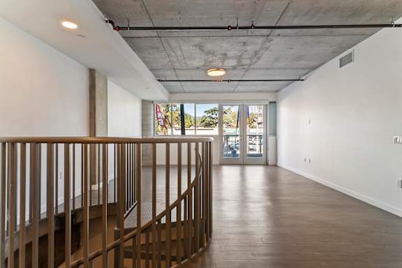 A long living area with a metal railing on the left side at Fusion Hollywood.