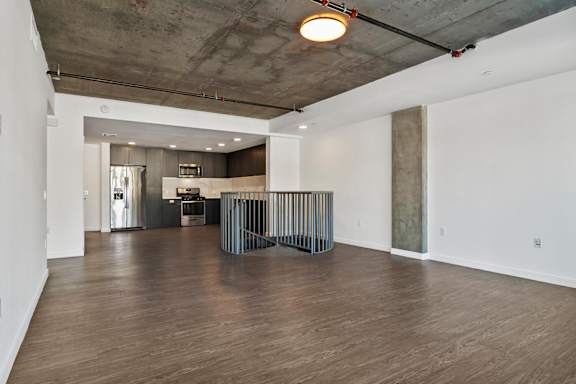A room with a wooden floor and a metal staircase in the middle at Fusion Hollywood.