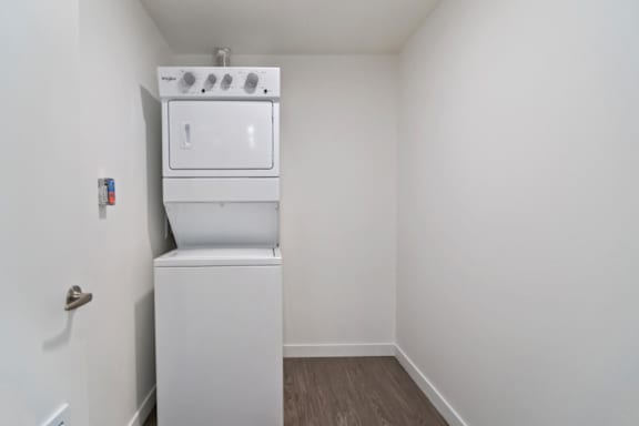 A stacked washer and dryer in a small room at Fusion Hollywood.