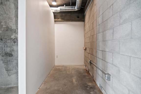 A room with a white wall and a concrete floor in a live/work apartment at Fusion Hollywood.