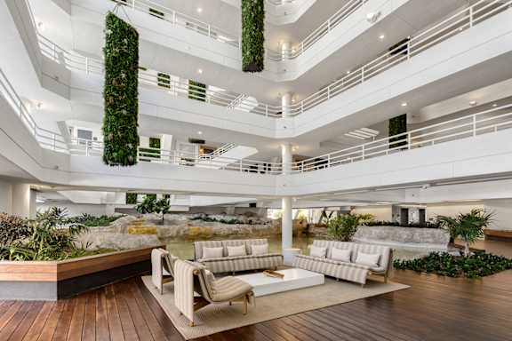 A white couch is in the middle of a wooden deck. at The Hamilton, Miami, 33137