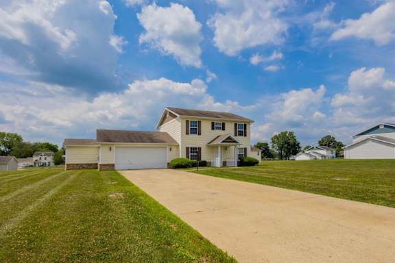 A large house with a driveway in front of it.