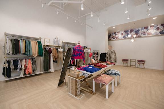A clothing store with a variety of clothes on display.