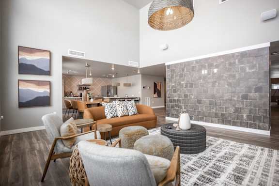 A living room with a grey stone wall and a grey and white rug.