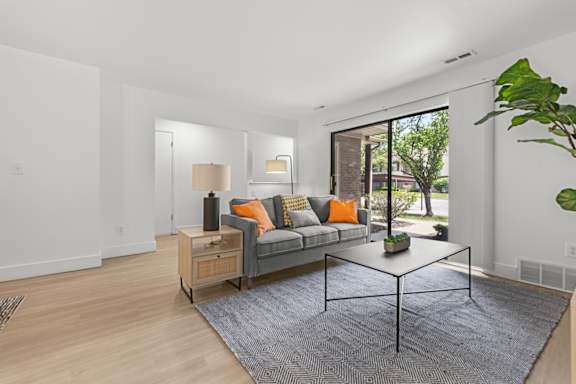 A living room with a grey couch and a coffee table.