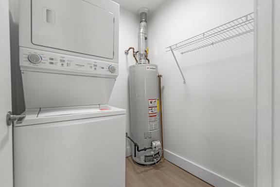 A white washing machine and dryer in a small laundry room.