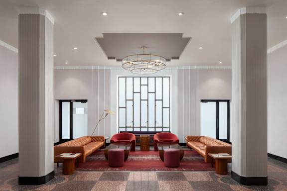 a lobby of a hotel with a reception desk