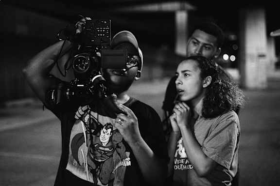 A man is holding a camera and a woman is standing next to him.