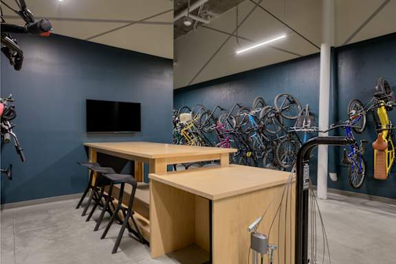 a room with tables and chairs and bicycles on the wall at The Lucy Boise Apartments, Idaho, 83702