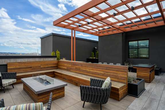 a rooftop patio with a seating area and a pergola at The Lucy Boise Apartments, Idaho, 83702