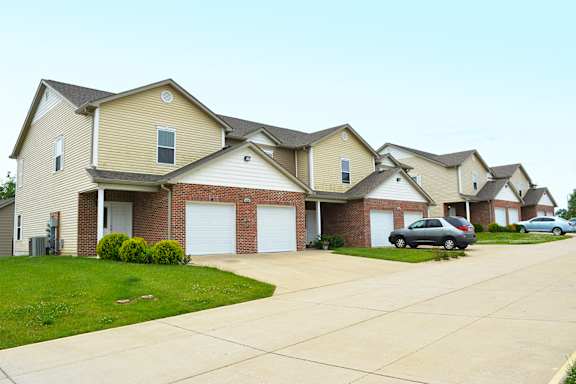 Cantwell crossing town homes exterior with single-car attached garage and driveway parking