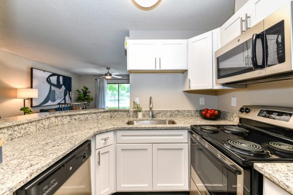 Kitchen with granite countertops and stainless steel appliances at 15Seventy, Chesterfield, MO 63017
