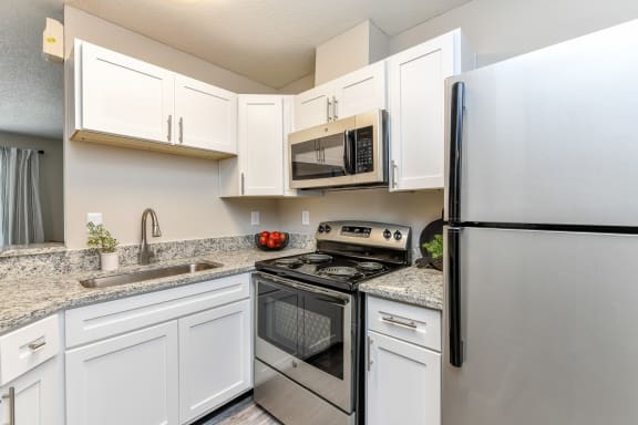 Kitchen with granite countertops and stainless steel appliances at 15Seventy, Chesterfield, MO 63017