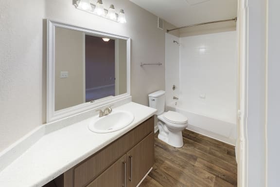 Full Bath with white countertops and updated modern lighting