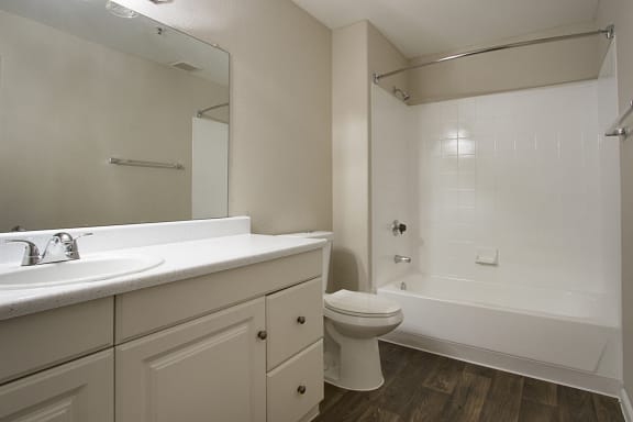 Full bath with white cabinets and countertops