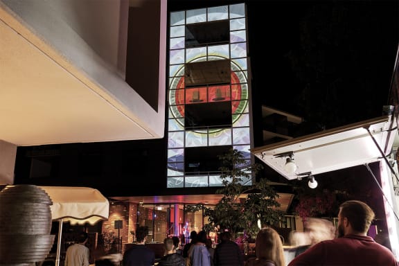 a building with a stained glass window at night