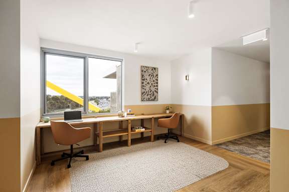a home office with a desk and a window