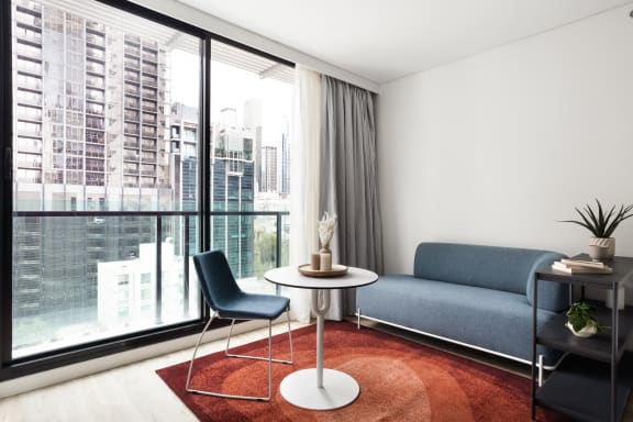 a living room with a large window and a couch and a table