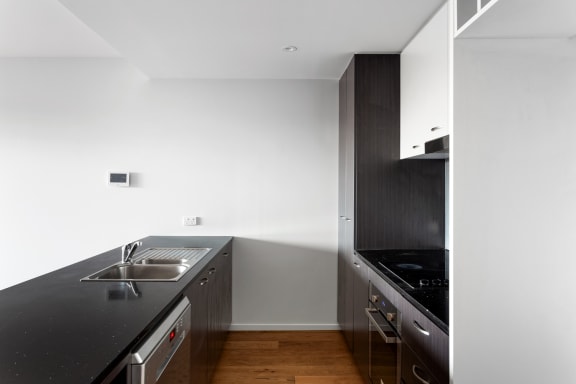 a kitchen with black countertops and a sink and a black