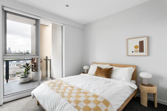 a bedroom with a bed and a large window