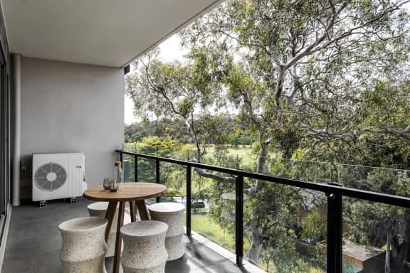 a room with a table and chairs on a balcony
