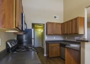Thumbnail 21 of 26 - Kitchen with black laminate countertops and walnut stained flat panel cabinet fronts