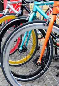 a row of colorful bikes on a cobblestone street