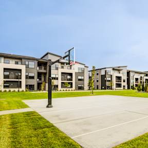 A large building complex with a grassy area in front.