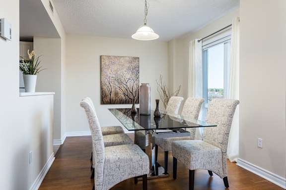 a dining room with a glass table and chairs