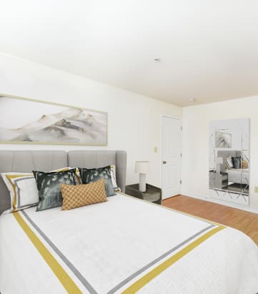 bedroom with bed, nightstand, and closet at jasper place apartments in washington dc