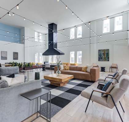 a living room filled with furniture and a large fireplace