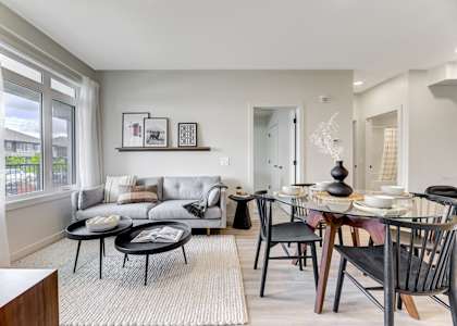 a living room and dining room with a table and chairs and a couch
